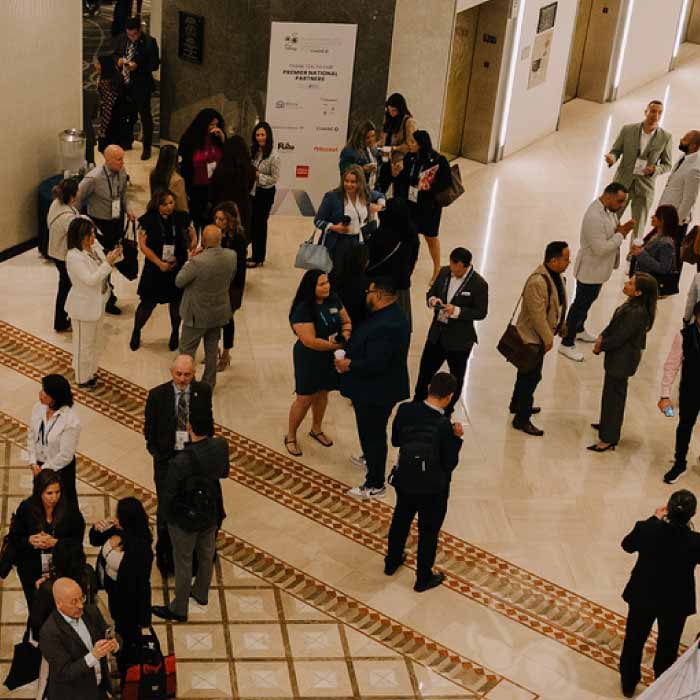 A wide angle image of several agents in a hallway at a conference